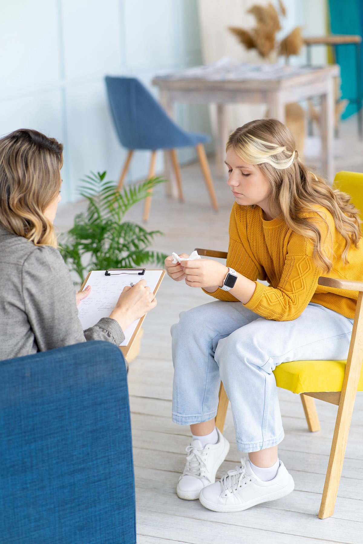 Teenage girl speaks with a counselor.