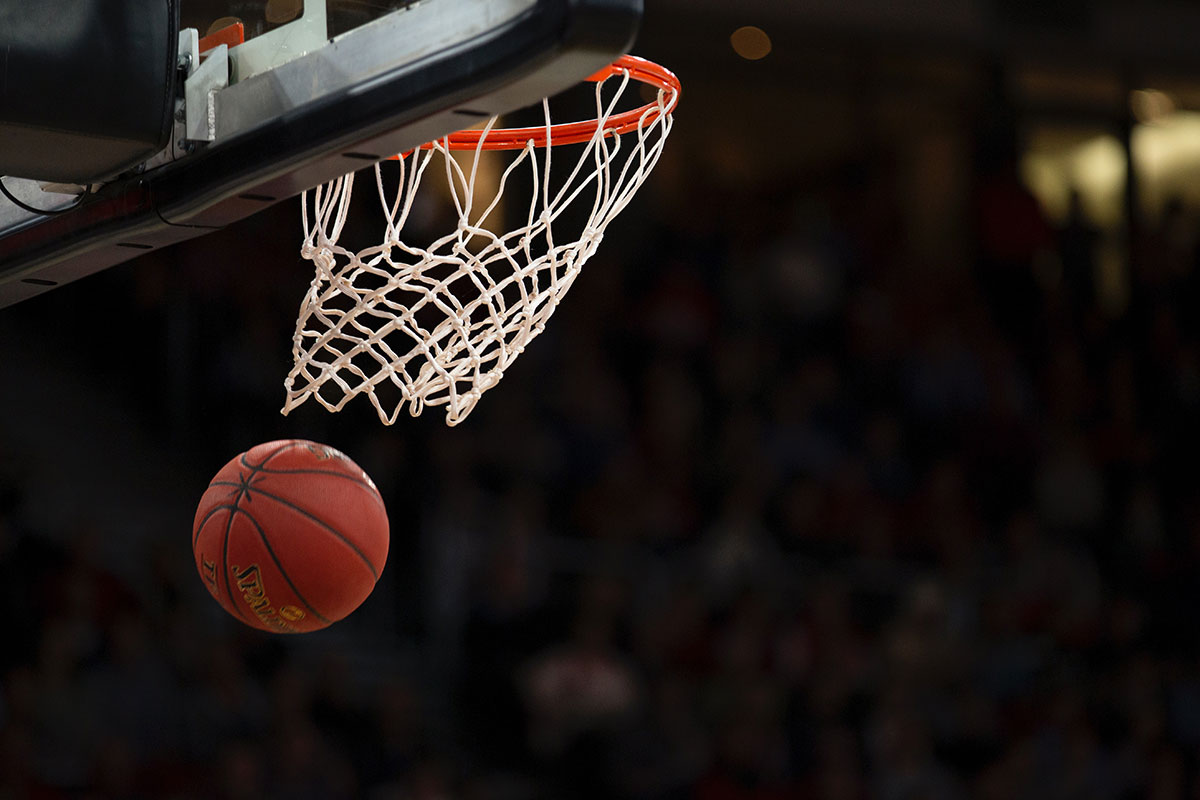 Close-up of a basketball swishing through a basketball net.