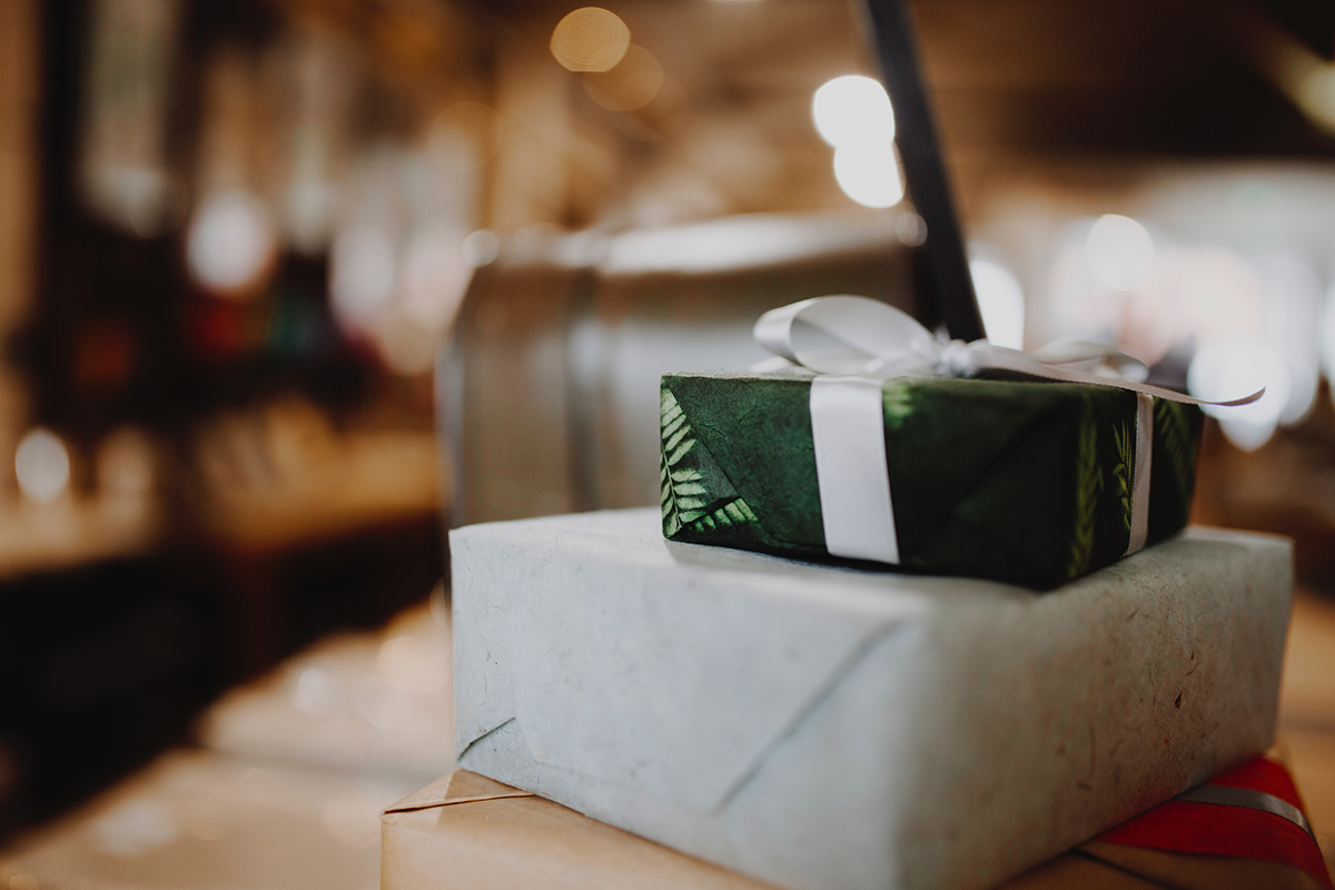 Two wrapped Christmas presents on a table.