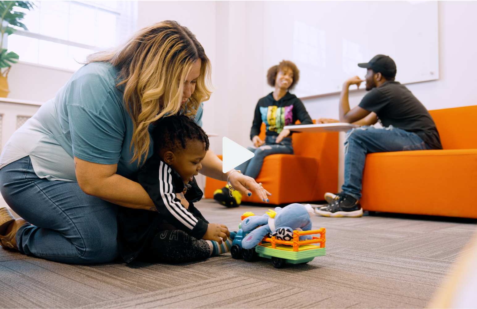 Doula Video- doula playing with baby while parents chat in background